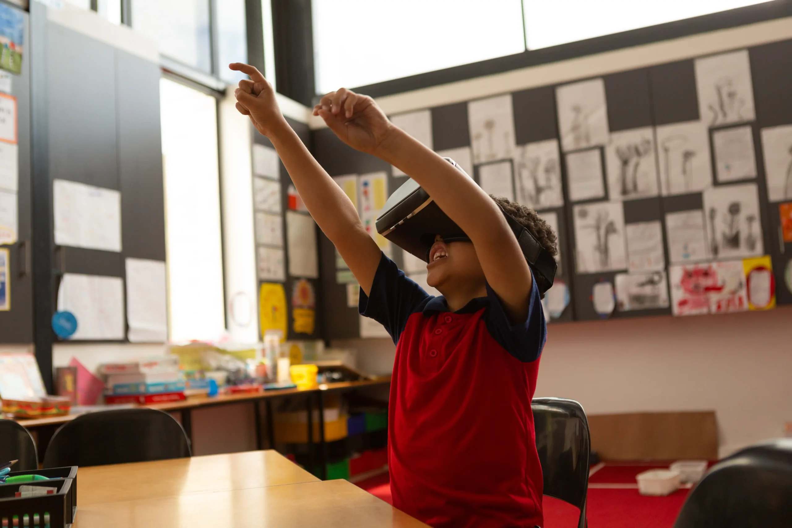 A Boy reaches for something in the virtual world he is interacting with in virtual reality.